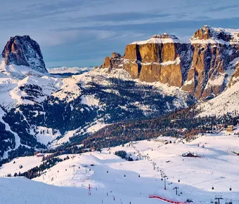 Skiing along the scenic Sellaronda route, Val di Fassa, surrounded by Dolomites peaks